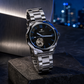 KINETIC Oceana black-dial stainless-steel watch on a blue-hour architectural plinth