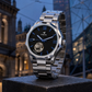 KINETIC Oceana black-dial stainless-steel watch in a Melbourne architectural blue-hour still