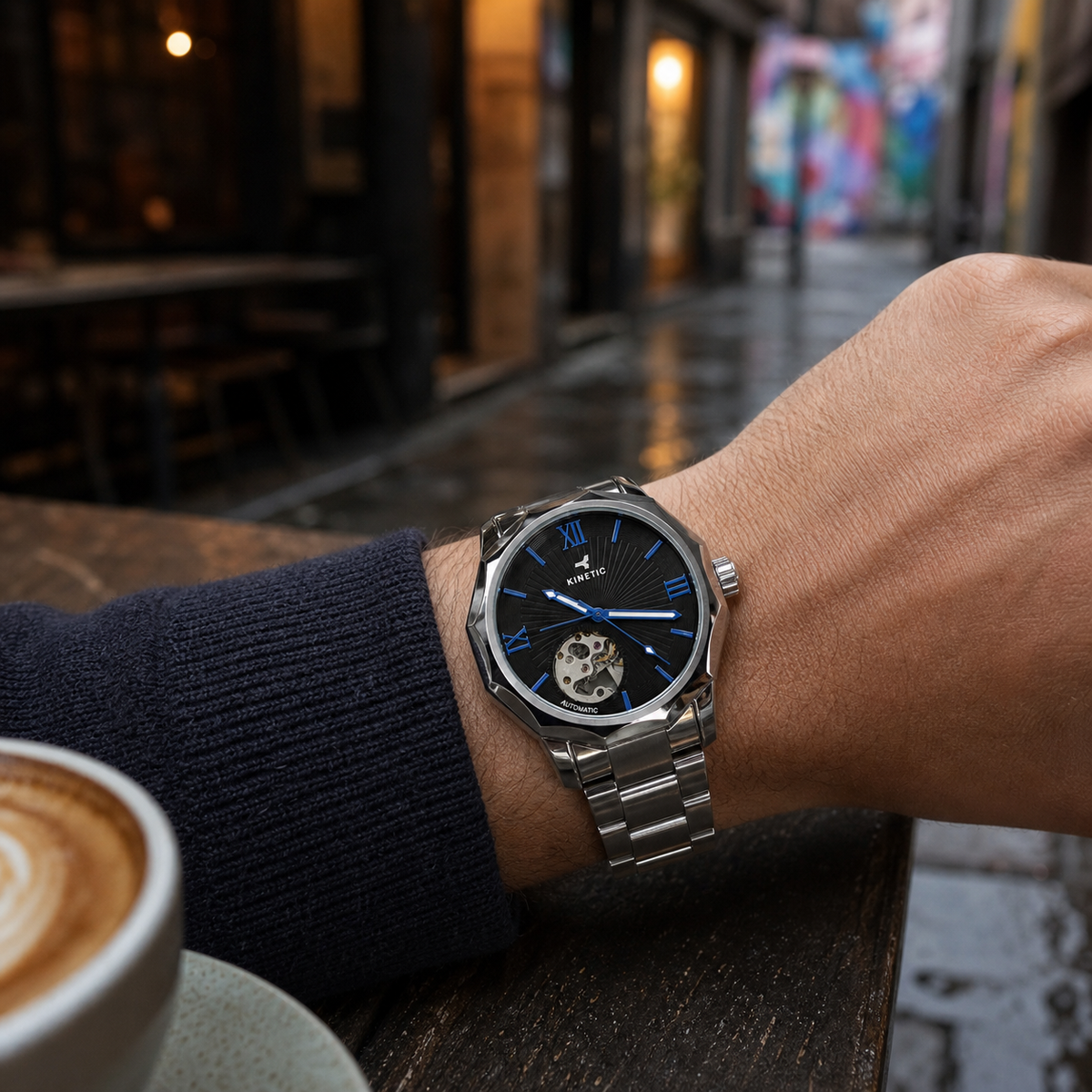 KINETIC Oceana black-dial stainless-steel watch worn at a Melbourne bluestone laneway cafe
