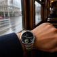 KINETIC Oceana black-dial stainless-steel watch worn during a rainy Melbourne tram commute