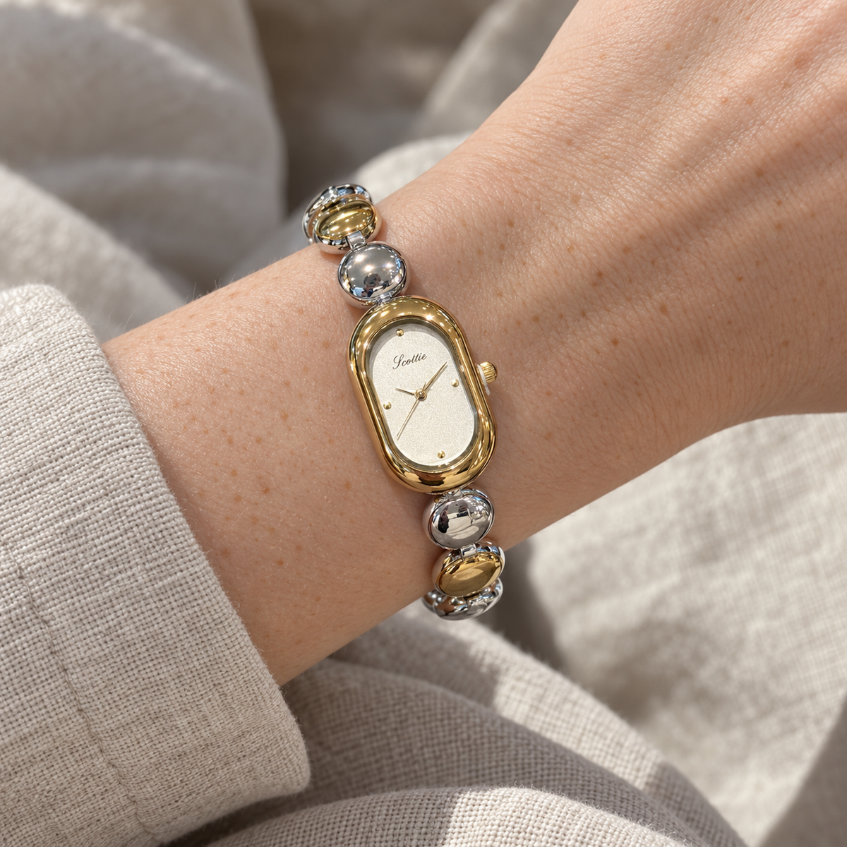 Scottie Duet watch worn beside an oat linen cuff