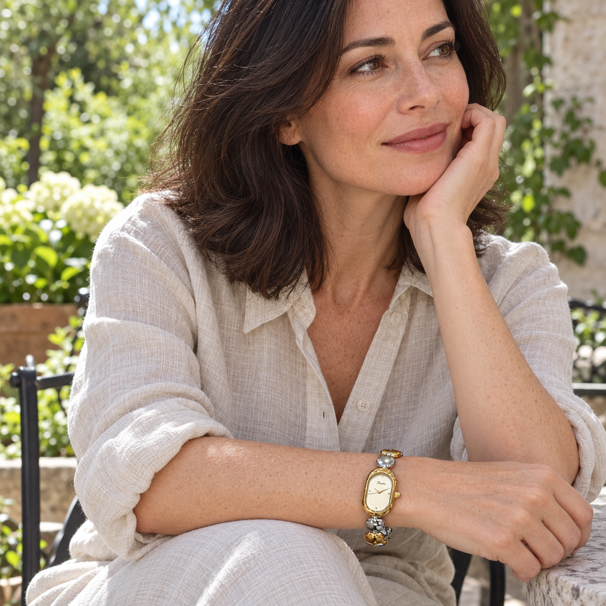 Scottie Duet watch worn with an oat linen shirt on a garden terrace