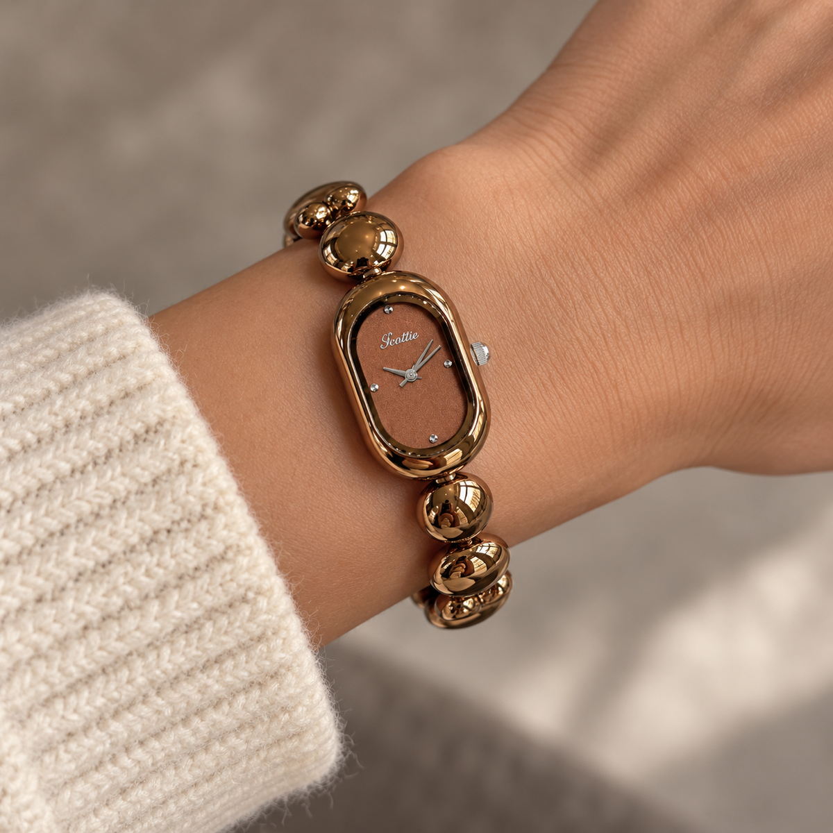 Scottie Espresso watch worn beside a cream knit sleeve