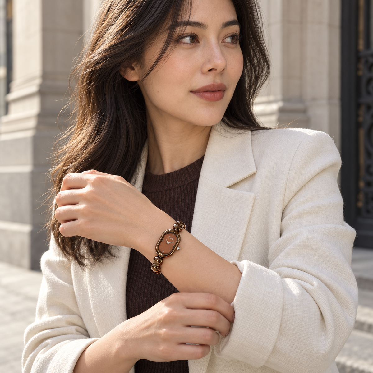 Scottie Espresso watch worn with a cream jacket in a city setting