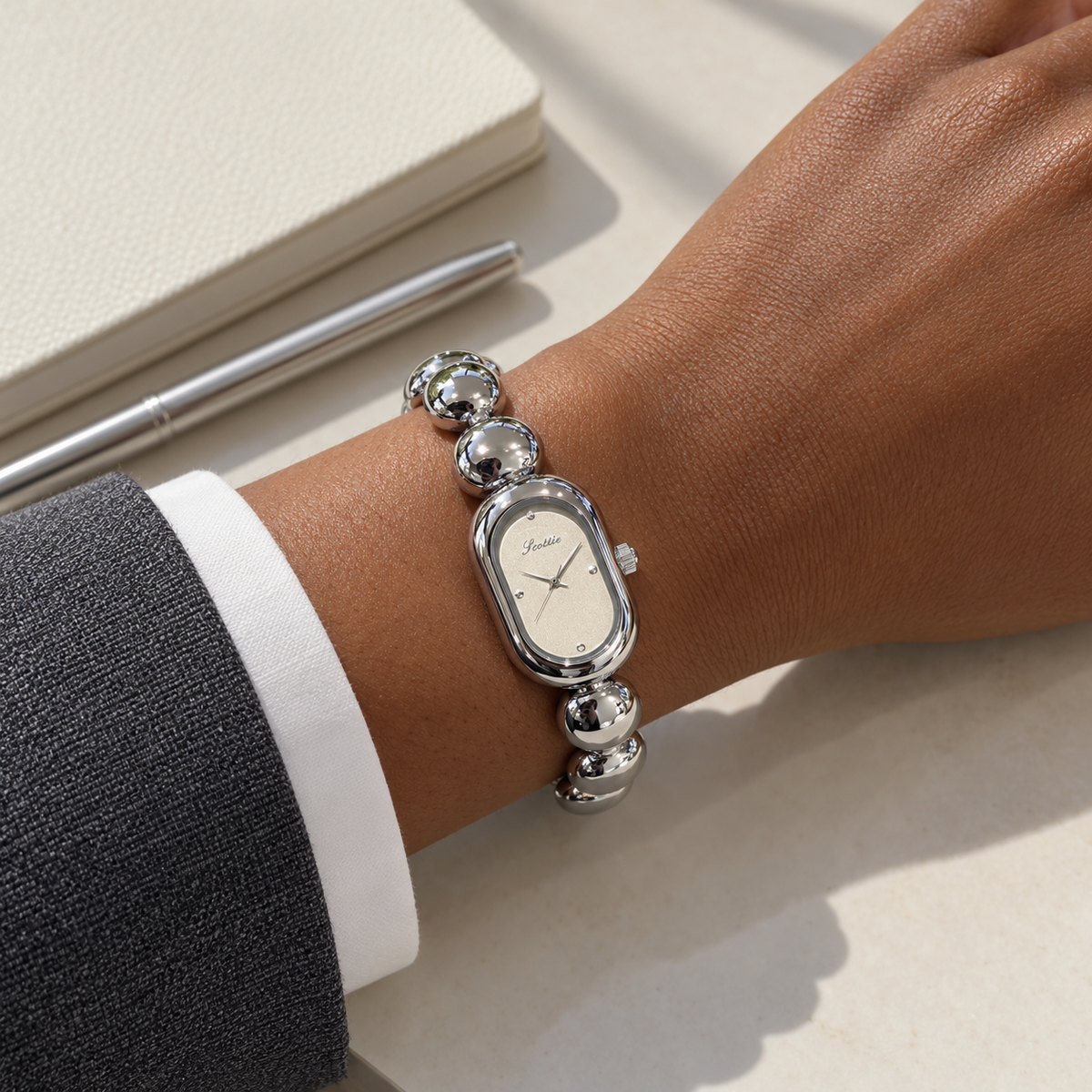 Scottie Mist watch styled with a grey jacket at a desk